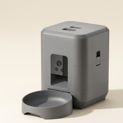 Smart pet feeder with camera and bowl on a cream background