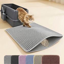 Cat stepping from litter box onto grey honeycomb litter trapping mat
