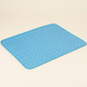 Blue quilted pet cooling mat on a cream background